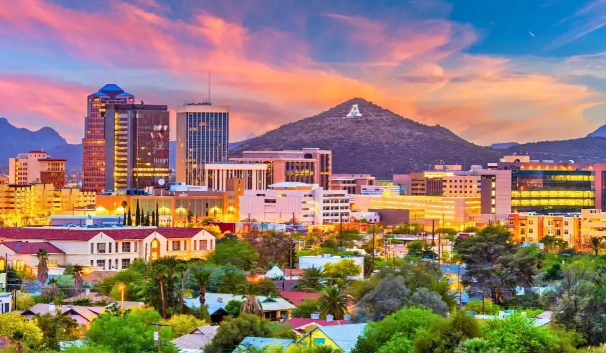 Sunset skyline of Tucson, Arizona, with mountains in the background.