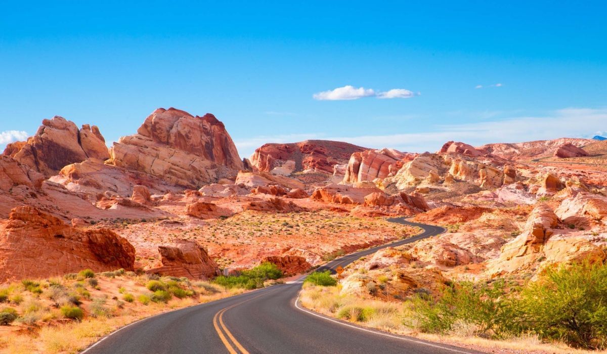 Scenic desert road in Valley of Fire, Nevada, under a blue sky