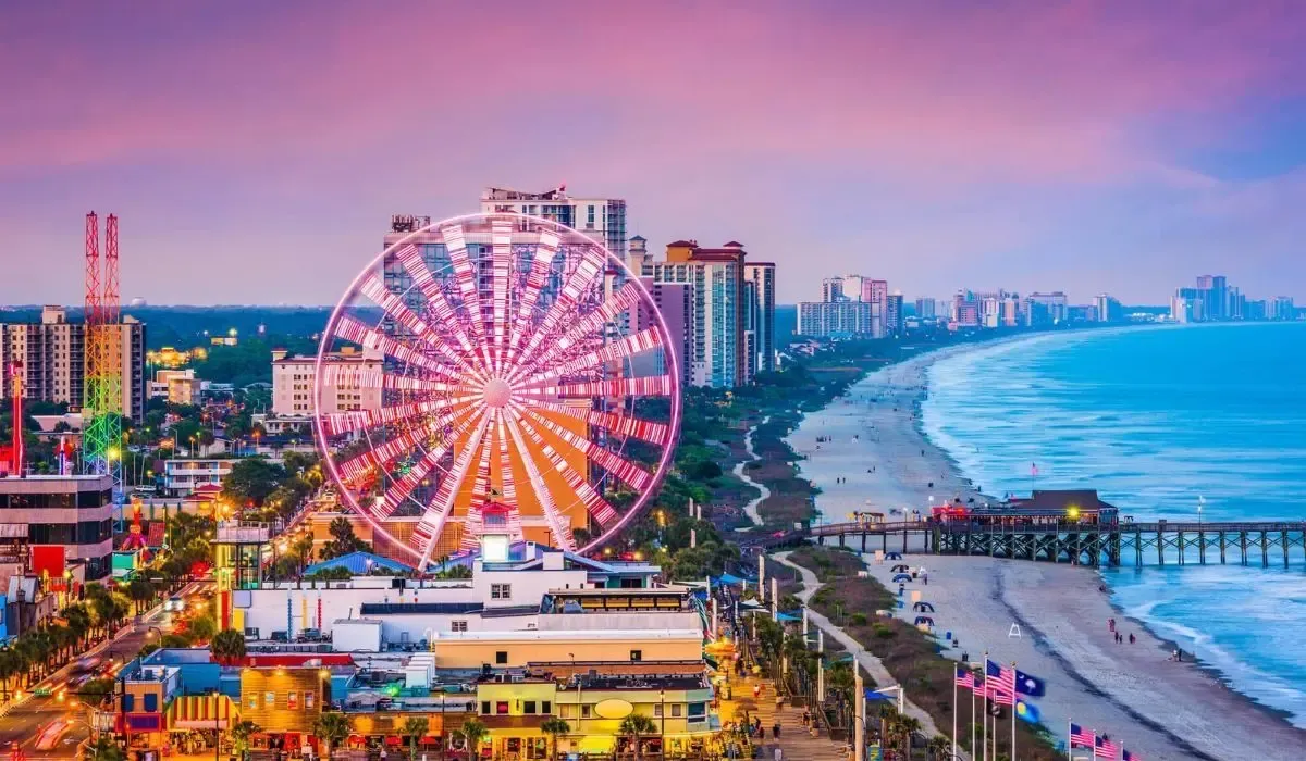 Myrtle Beach, South Carolina, lit up at dusk with ferris wheel and ocean pier