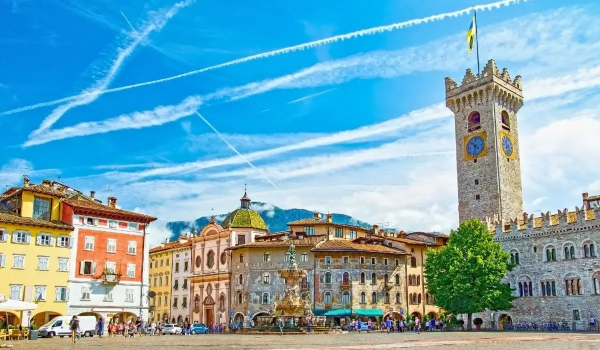 Colourful buildings and the medieval tower in Piazza Duomo, Trento. Pay university fees in euros from Canada with MTFX and enjoy better exchange rates than traditional banks.