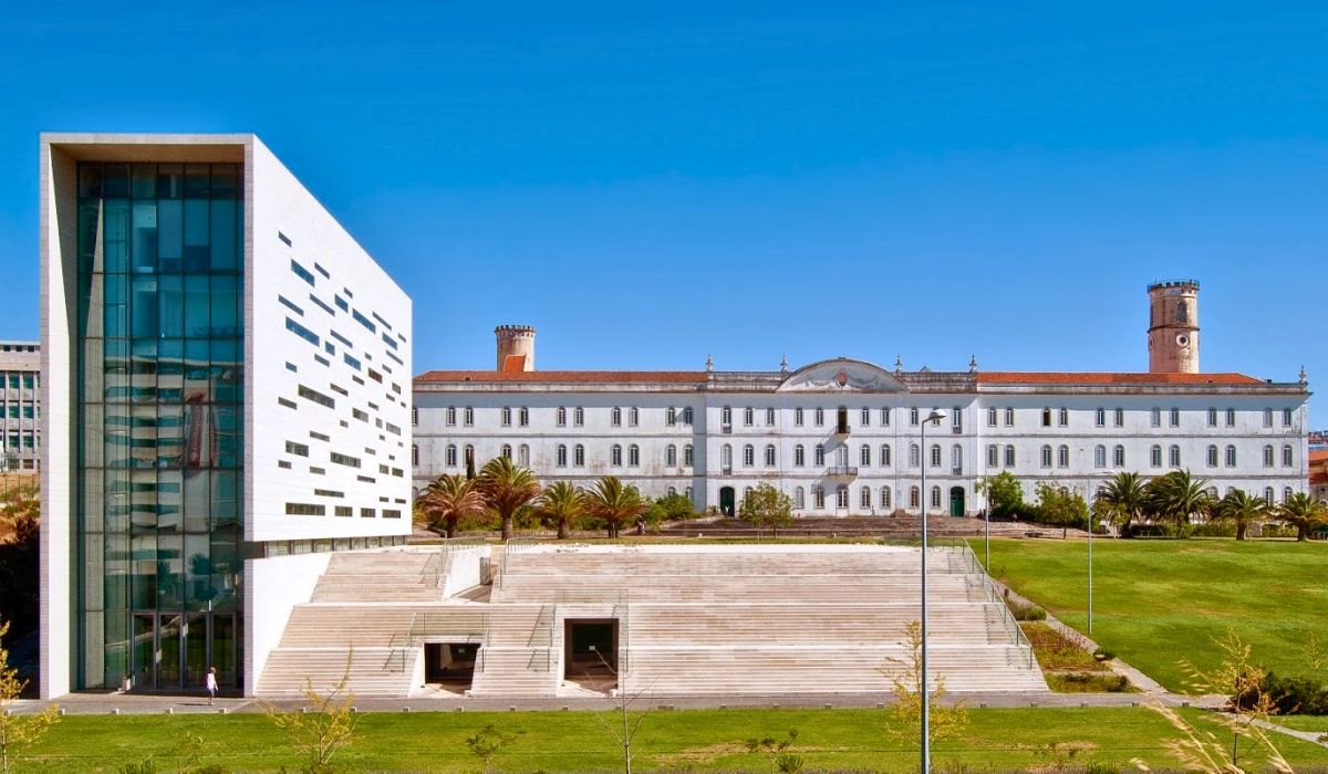 An image of Universidade Nova de Lisboa, showcasing sleek, modern buildings with glass exteriors and open communal spaces.
