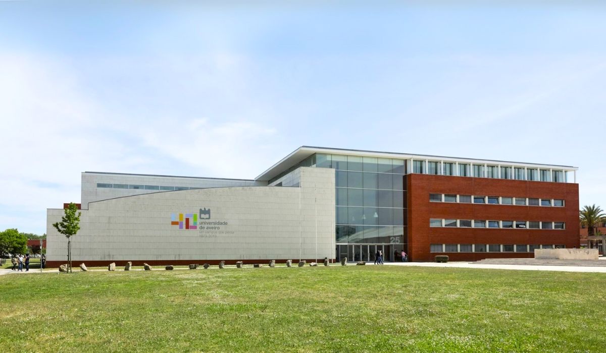 A photograph of Universidade de Aveiro's campus, highlighting its innovative architectural design with interconnected structures and landscaped areas.
