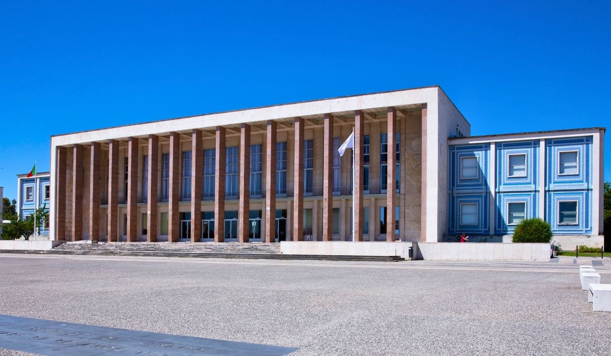 An image of Universidade de Lisboa's campus, featuring expansive academic buildings with modern facades and tree-lined walkways.