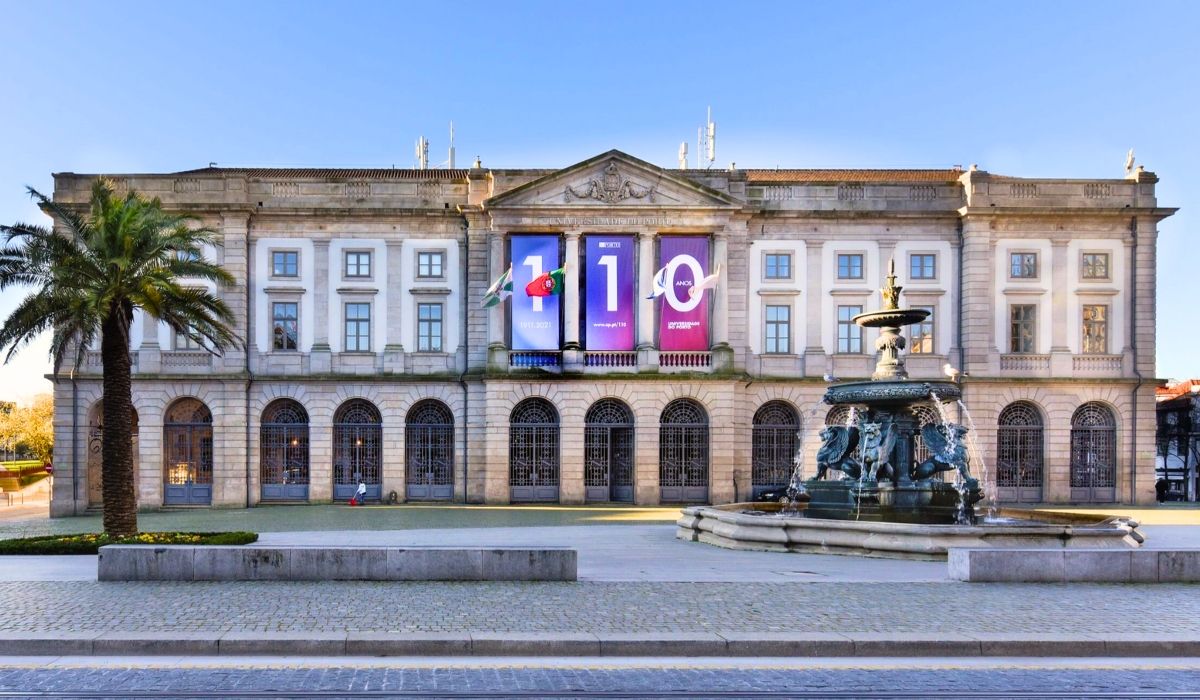 A photograph of Universidade do Porto's historic campus, highlighting classical architecture with stone columns and decorative elements.