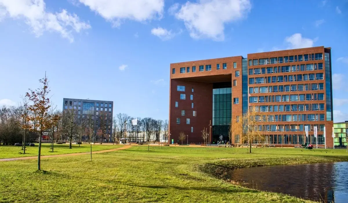 Modern red brick campus buildings of Wageningen University surrounded by green fields. Canadian students can send EUR tuition payments securely from Canada with MTFX for fast transfers and better rates than banks.