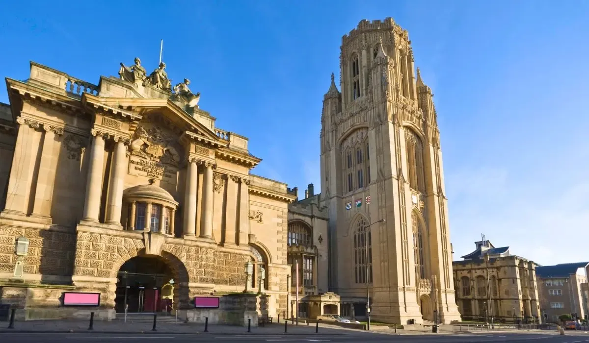 A scenic image of the University of Bristol campus, showcasing a mix of historic and modern buildings set against a vibrant urban backdrop.