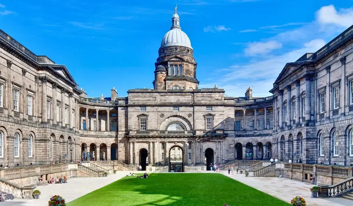 Old College quadrangle of the University of Edinburgh featuring classical stone buildings and a central green lawn.