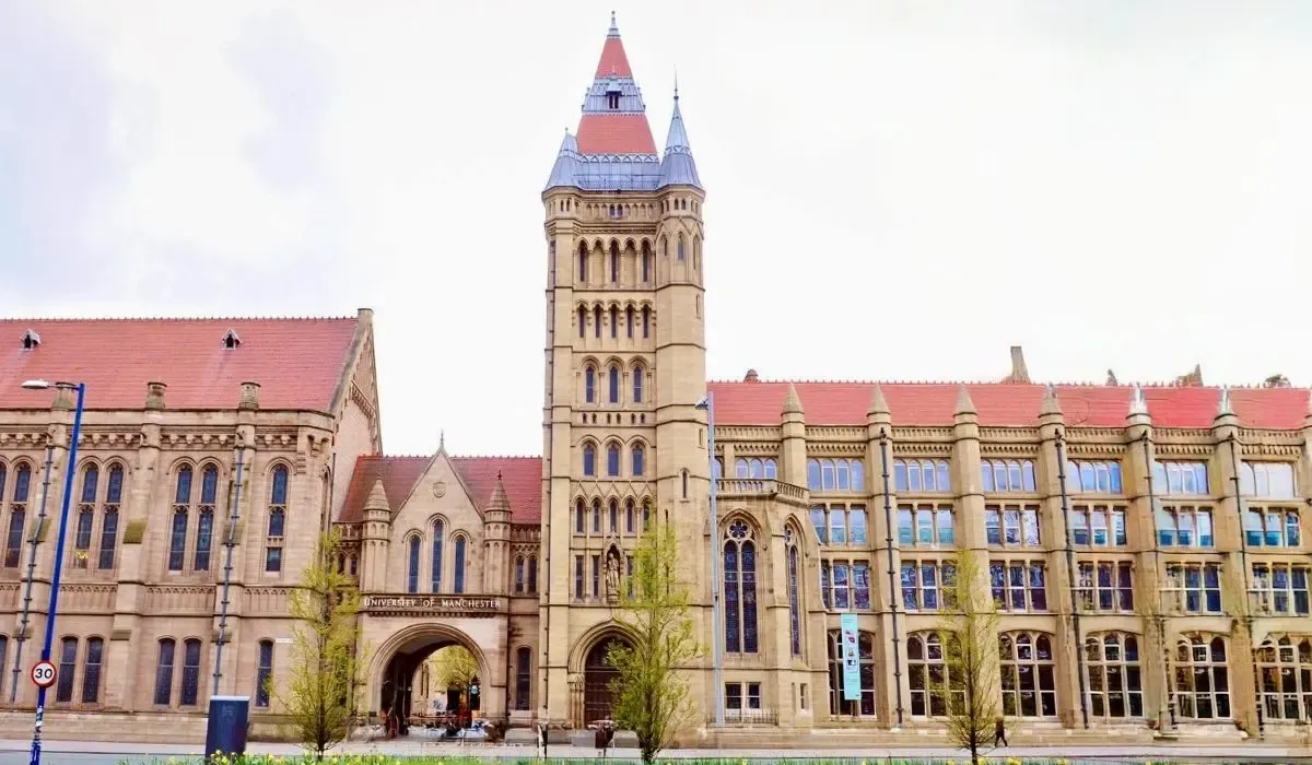 Gothic revival architecture and iconic Whitworth Hall at the University of Manchester with red rooftops.