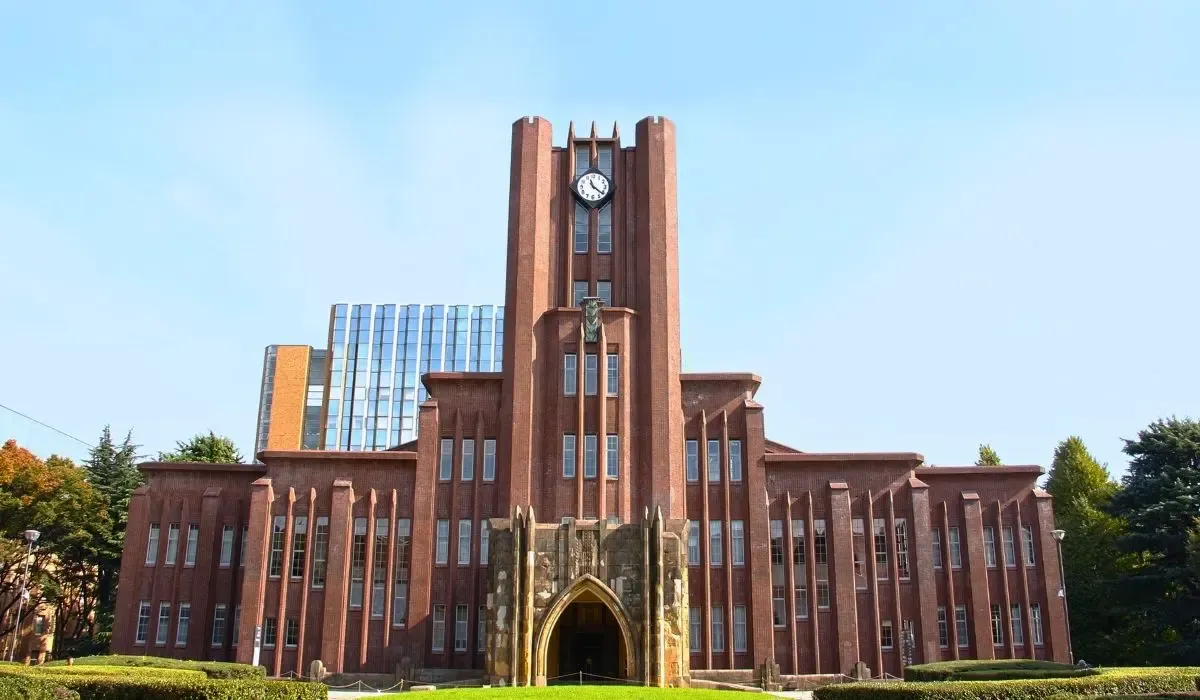 The iconic Yasuda Auditorium at the University of Tokyo, showcasing its red-brick façade and traditional Japanese architectural elements.