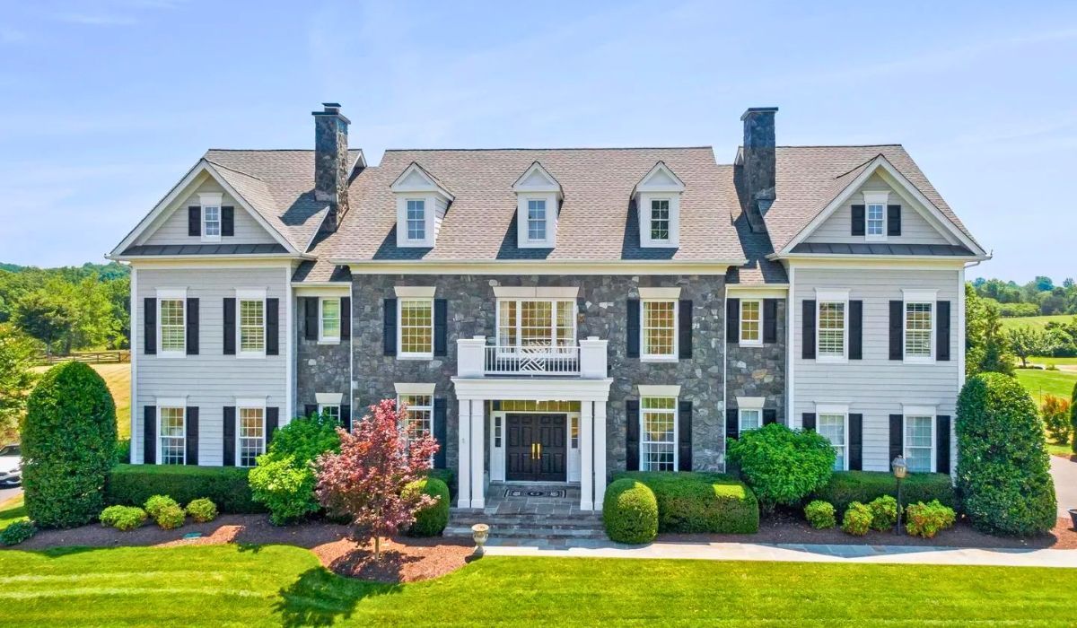 Stately colonial-style home in Virginia with symmetrical stone façade and dormer windows.