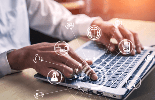 A business professional using a laptop, with digital icons representing global currency symbols and payment networks, symbolizing MTFX's integrated payment solutions.