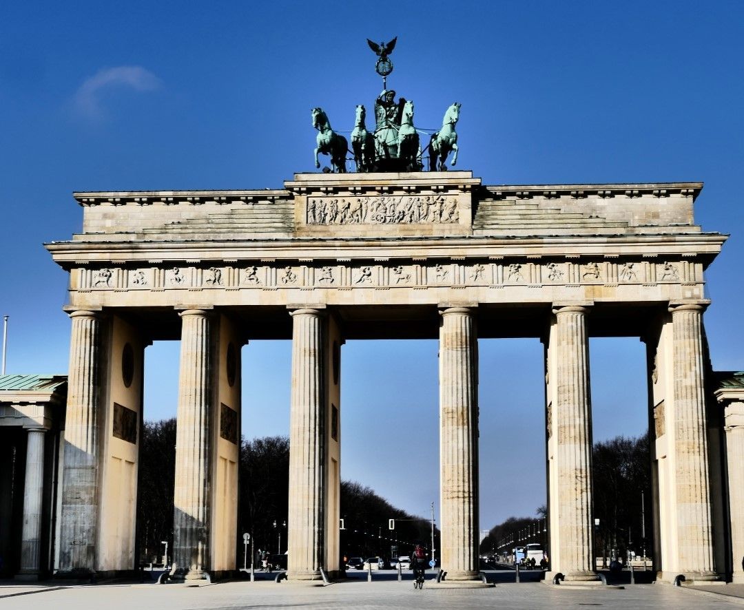 The Brandenburg Gate in Berlin, Germany, under a clear blue sky, showcasing its neoclassical architecture and iconic columns.