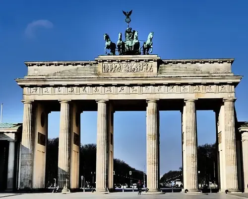 The Brandenburg Gate in Berlin, Germany, under a clear blue sky, showcasing its neoclassical architecture and iconic columns.