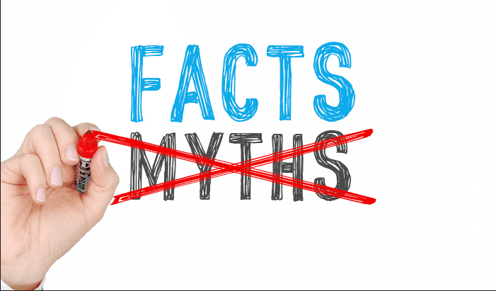 Hand crossing out the word 'Myths' and highlighting 'Facts' beside a graphic of the Earth surrounded by currency symbols, representing debunked misconceptions about international money transfers.