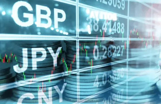 GBP, JPY, and CNY symbols over stacked coins and candlestick chart, depicting a currency management strategy for budgeting FX rates.
