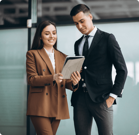 Two people reviewing property purchase options on a tablet, representing strategic planning for buying property abroad with competitive exchange rates