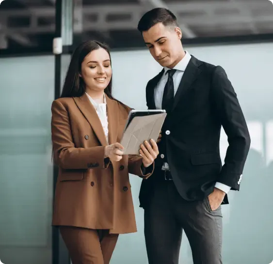 Two people reviewing property purchase options on a tablet, representing strategic planning for buying property abroad with competitive exchange rates