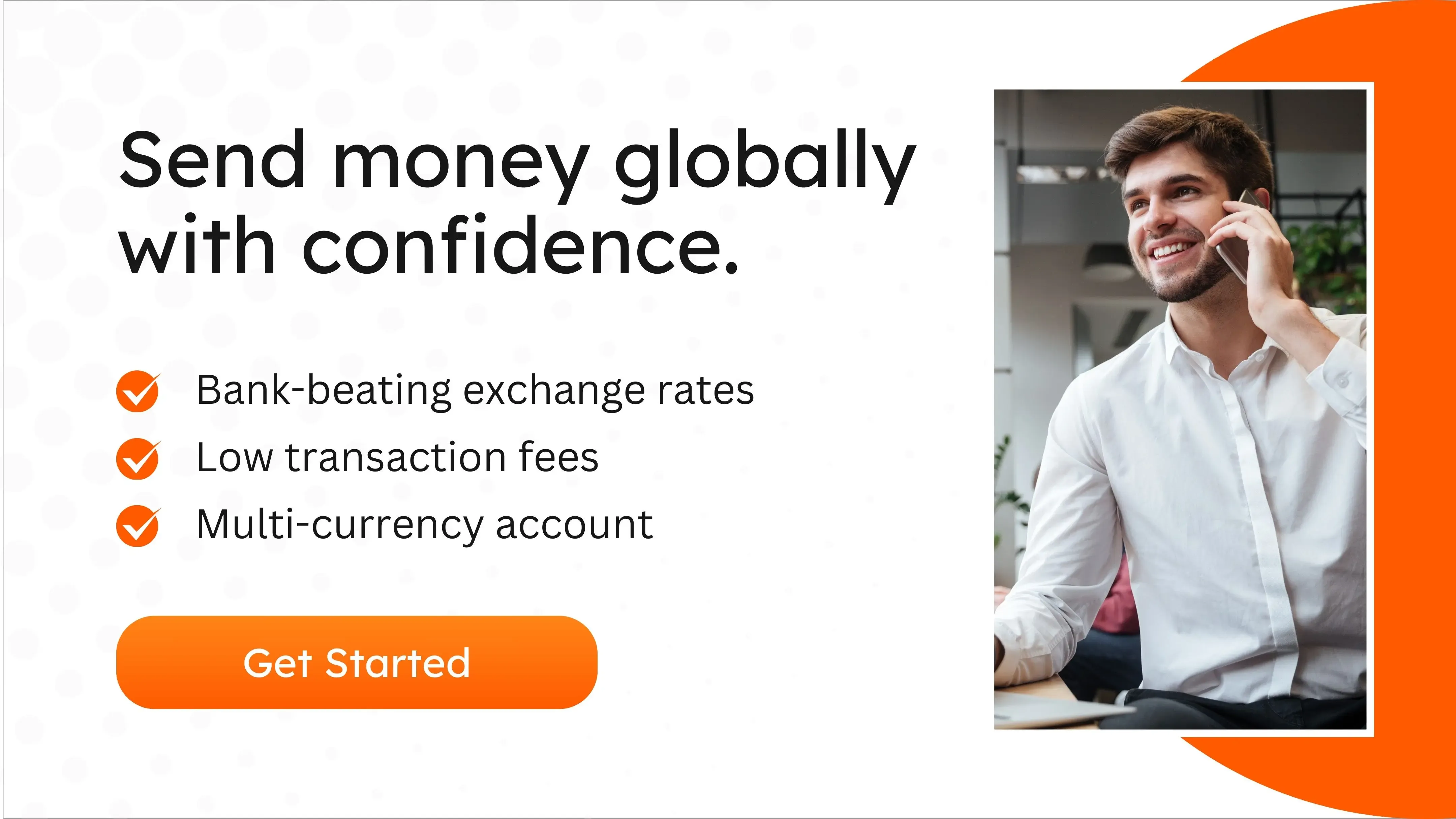  Smiling professional on a phone call, sitting at a desk with a laptop, representing confidence in managing global wire transfers using MTFX’s cost-effective FX solutions.