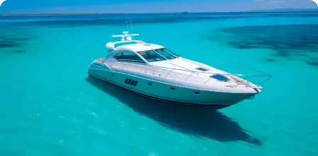 White yacht on clear turquoise water, symbolizing high-value large international money transfers
