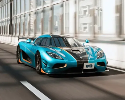 Blue hypercar with orange accents driving on a modern city bridge in daylight