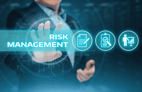Business professional interacting with a digital interface highlighting “Risk Management” alongside finance and strategy icons.