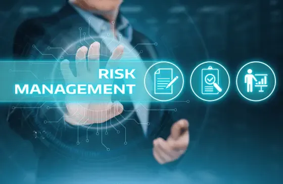 Business professional interacting with a digital interface highlighting “Risk Management” alongside finance and strategy icons.