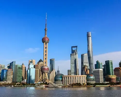  Modern skyline of Shanghai viewed from across the river, representing China's economic landscape and a common destination to send money to China for business or family.