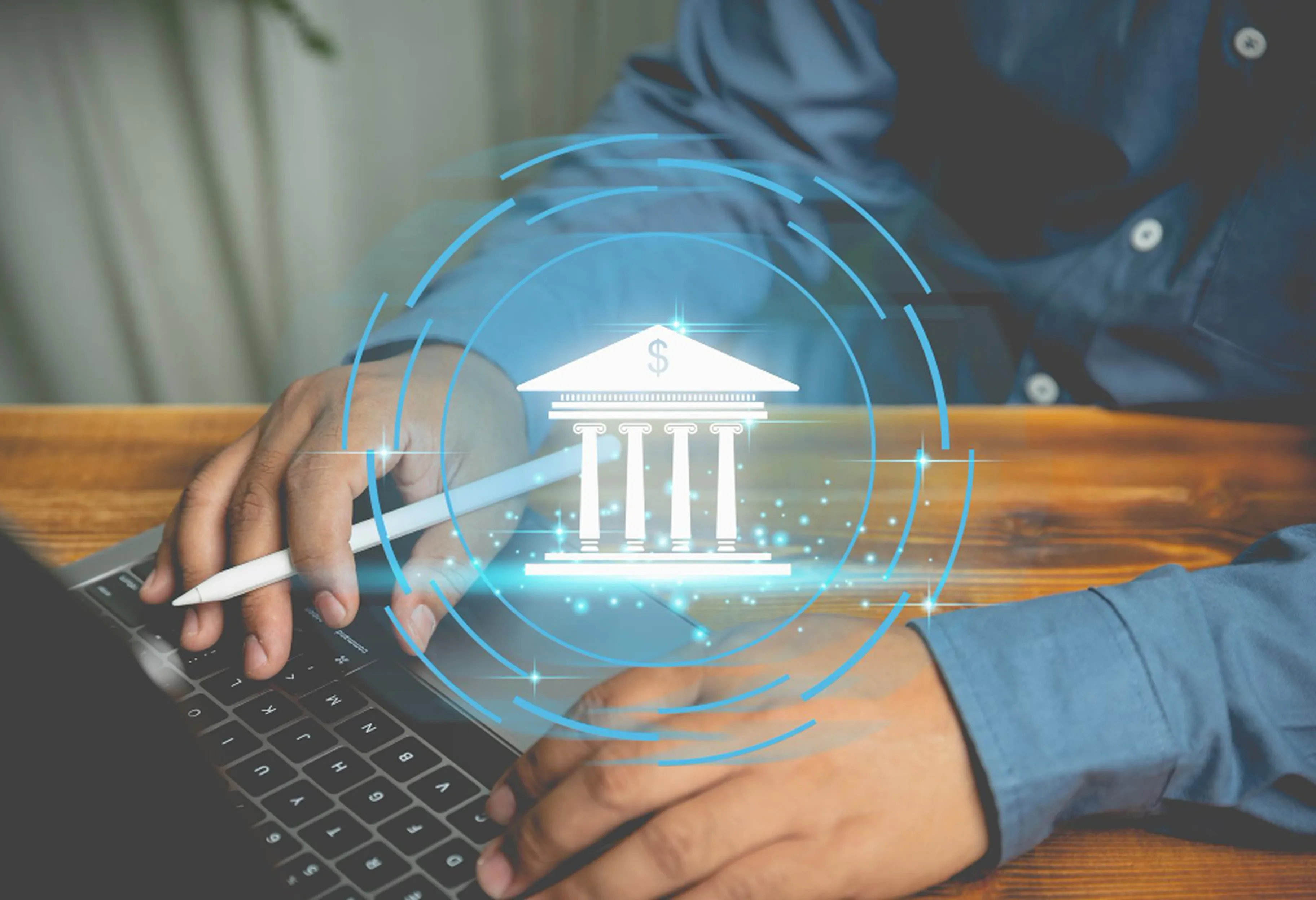 Business professional using a laptop with a digital banking icon overlay, representing secure online financial transactions and global payments.