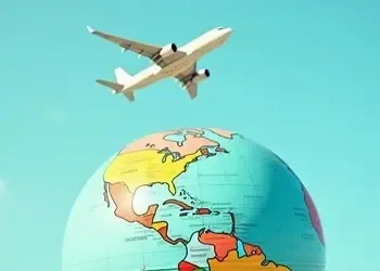 Airplane flying over a globe representing global mobility and international money transfers for expats.