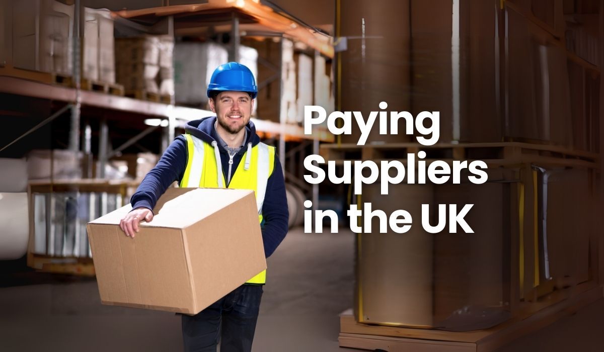 Hero image visual featuring a British warehouse worker iin safety gear holding a box and smiling.