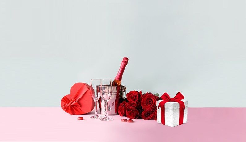 Valentine’s Day setup with roses, champagne, gift boxes, and heart decorations — symbolizing love, celebration, and thoughtful gifting for global occasions.