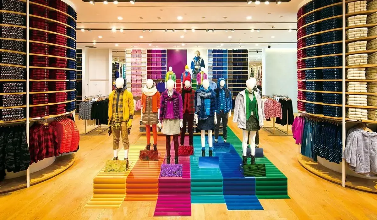 Colorful clothing display with mannequins dressed in winter apparel at a retail fashion store showcasing a wide range of garments and accessories.
